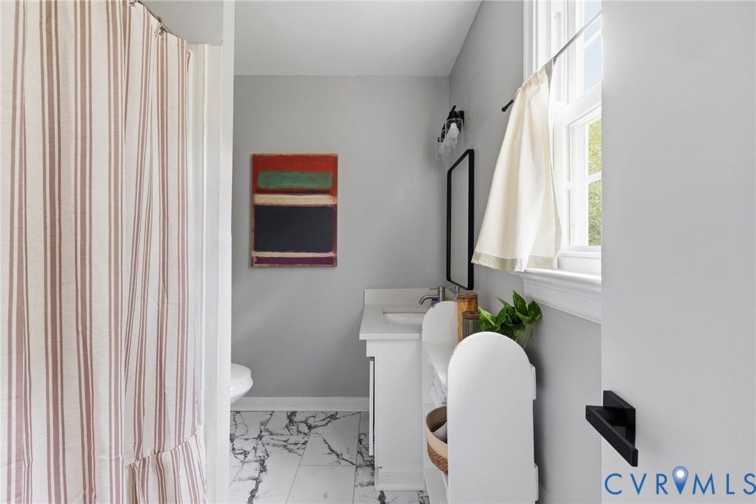 404 Aubery Road, Henrico, VA 23229 Bathroom featuring marble-look flooring, shower, and vanity with white quartz counter