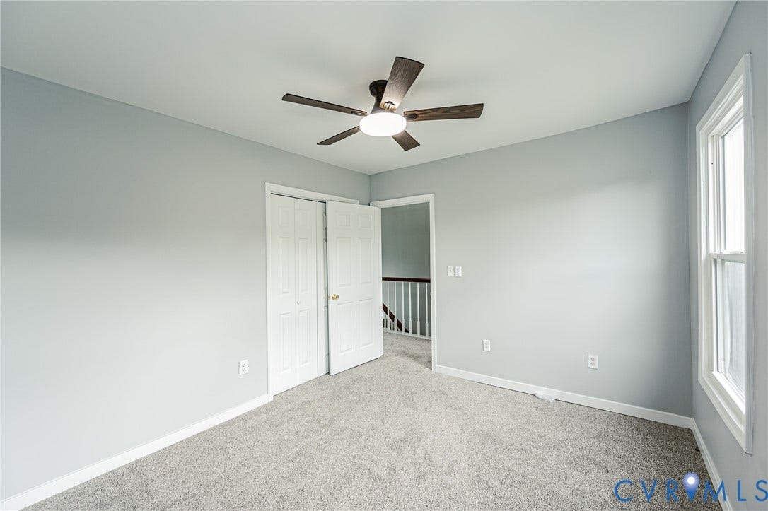 3903 Delmont Street, Henrico, VA 23222 Carpeted room featuring light gray wall paint, a ceiling fan with integrated lighting, a double-panel closet, and a white-framed window