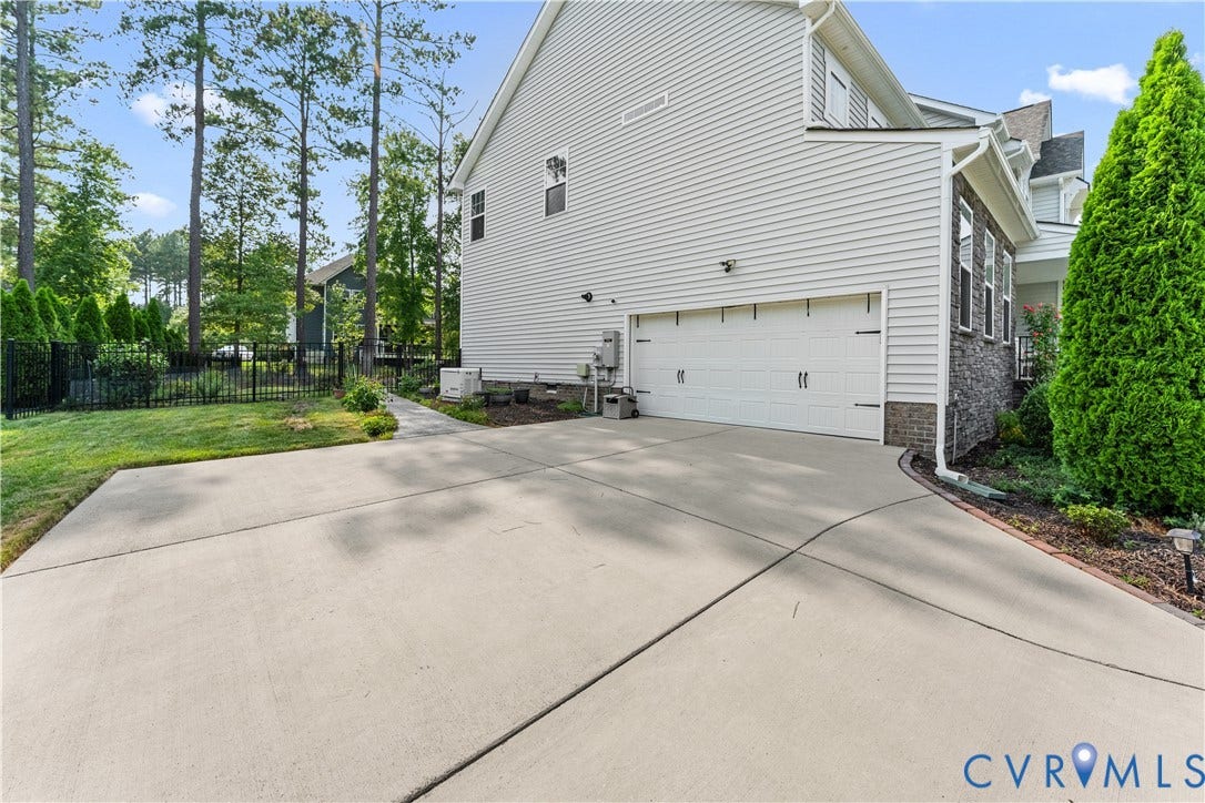 8800 Glen Royal Drive, Chesterfield, VA 23832 Exterior featuring a side-entry garage with a concrete driveway and an adjacent landscaped bed