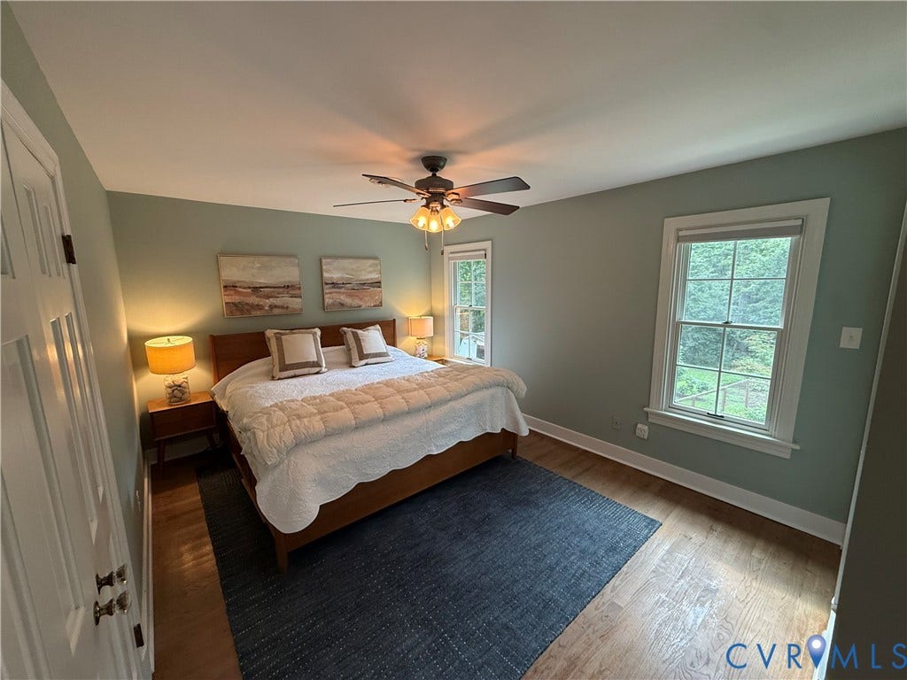 2312 Judes Ferry Road, Powhatan, VA 23139 Bedroom featuring warm wood-finish flooring, light green walls, and white trim