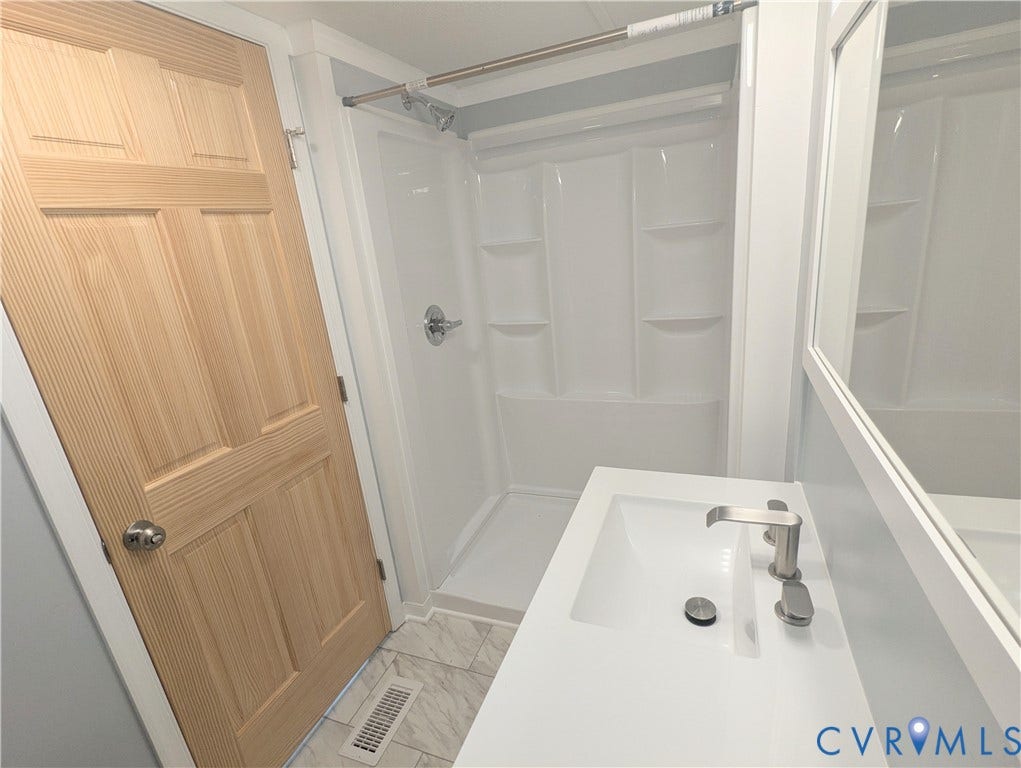 5959 Derwent Road, Powhatan, VA 23139 Integrated shower and tub unit featuring built-in shelving