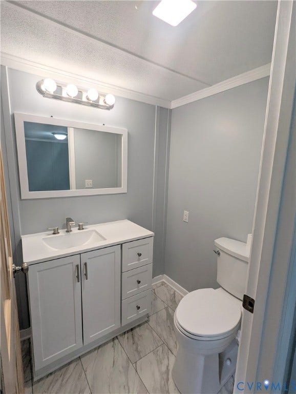 5959 Derwent Road, Powhatan, VA 23139 Bathroom featuring a white vanity with integrated sink, brushed nickel faucet, a rectangular mirror, and a toilet