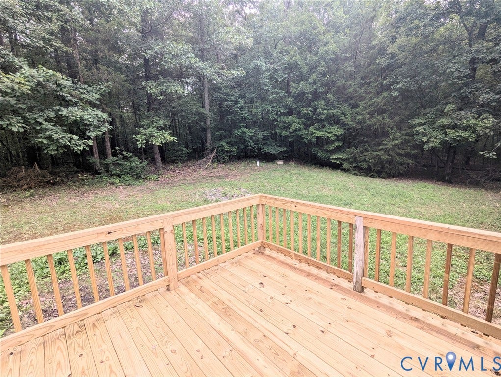 5959 Derwent Road, Powhatan, VA 23139 Expansive wood deck with natural wood railing overlooking a grassy yard with mature trees