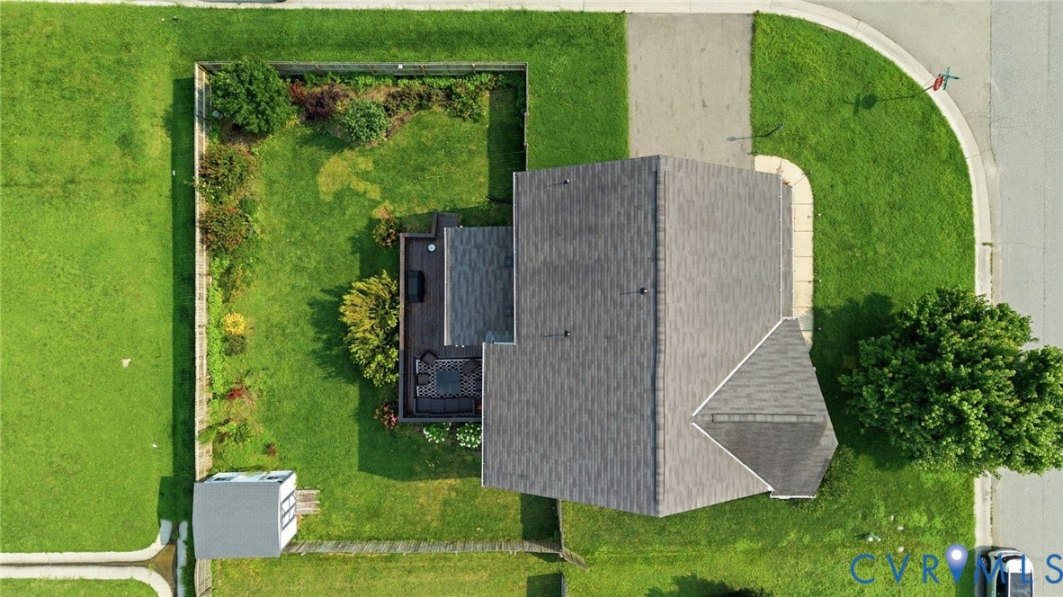 5713 Kings Grove Drive, Kings Grove, Chesterfield, VA 23832 Spacious property featuring a dark-toned shingled roof, extensive green lawn, and a private wooden deck