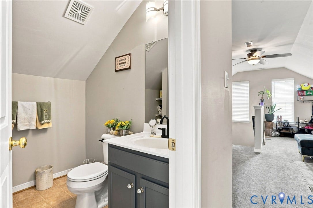 5713 Kings Grove Drive, Kings Grove, Chesterfield, VA 23832 Powder room featuring a single vanity with a dark gray cabinet, white countertop, and a black faucet