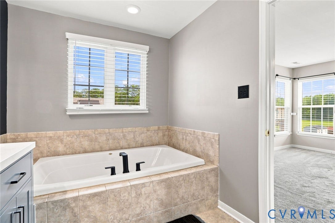 5713 Kings Grove Drive, Kings Grove, Chesterfield, VA 23832 Built-in bathtub with tiled surround featuring black fixtures, white window blinds, and recessed ceiling lighting