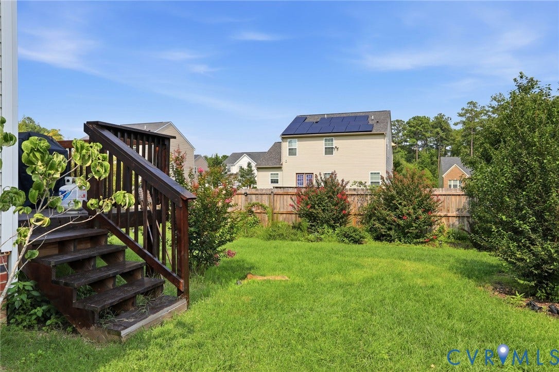 5713 Kings Grove Drive, Kings Grove, Chesterfield, VA 23832 Expansive backyard with a manicured lawn, bordered by a wood privacy fence and mature trees
