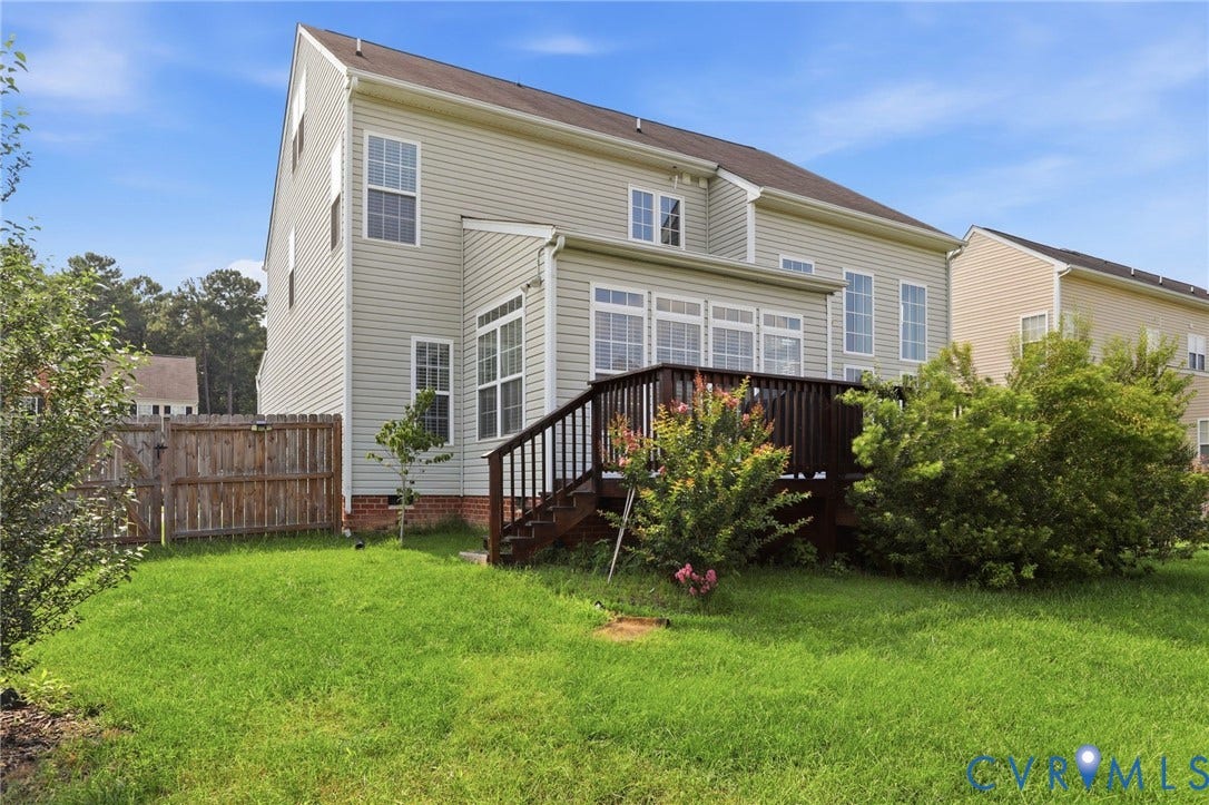 5713 Kings Grove Drive, Kings Grove, Chesterfield, VA 23832 Rear exterior featuring a spacious wooden deck with railings, light-colored siding, and multiple windows