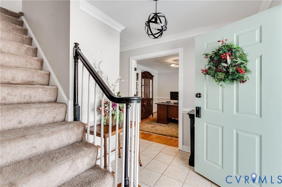 11611 Riverpark Way, Chesterfield, VA 23838 Entryway featuring panel door, tile flooring, and a staircase with carpeted treads and a black handrail