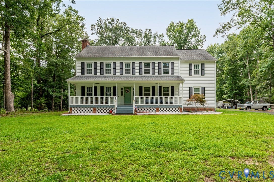 11611 Riverpark Way, Chesterfield, VA 23838 White two-story residence featuring a full-width front porch with white railings and lattice skirting, a light blue front door, and black window shutters