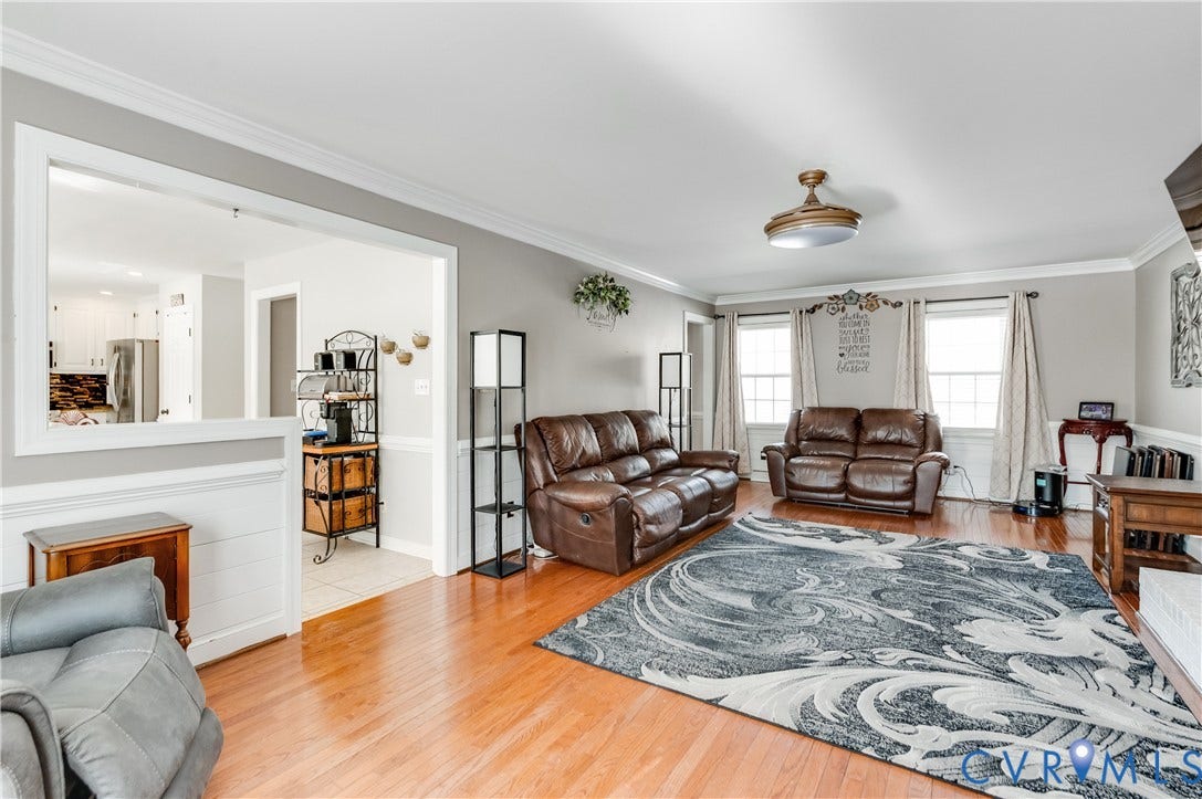 11611 Riverpark Way, Chesterfield, VA 23838 Spacious living area featuring wood-finish flooring, light gray wall paint, and white crown molding