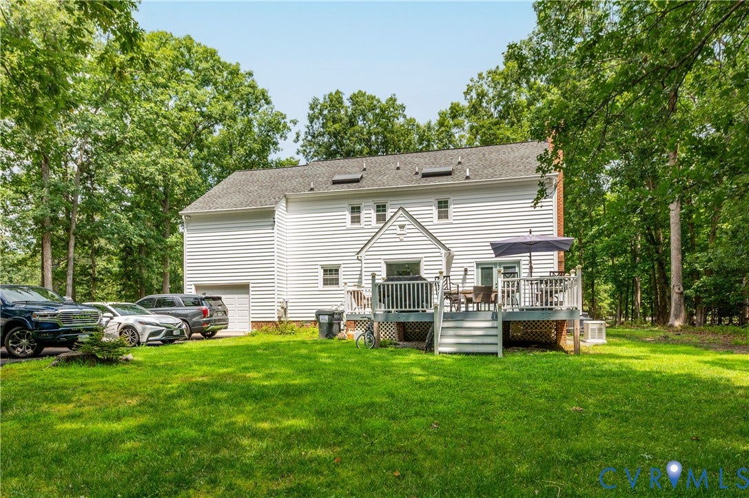 11611 Riverpark Way, Chesterfield, VA 23838 Rear exterior featuring a multi-level wood deck with white railings, a lower-level garage door, and white siding