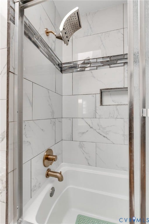 11611 Riverpark Way, Chesterfield, VA 23838 Bathtub with white subway tile surround, accented by a decorative glass mosaic band