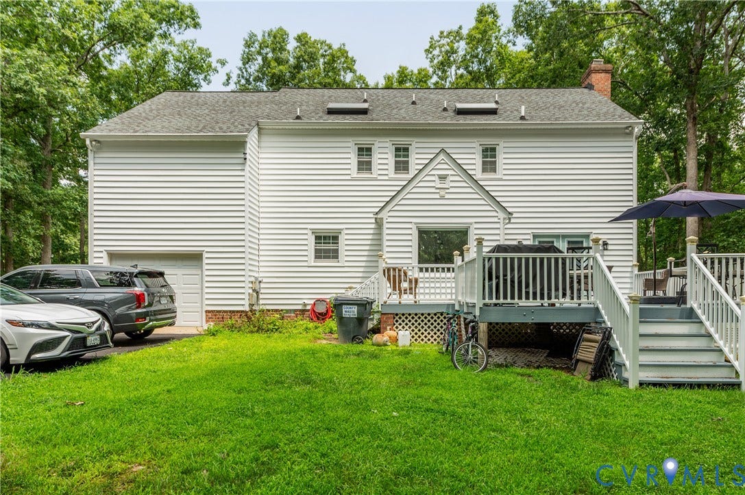 11611 Riverpark Way, Chesterfield, VA 23838 Rear exterior featuring white horizontal siding, a multi-level wood deck with white railings, and a single-car garage