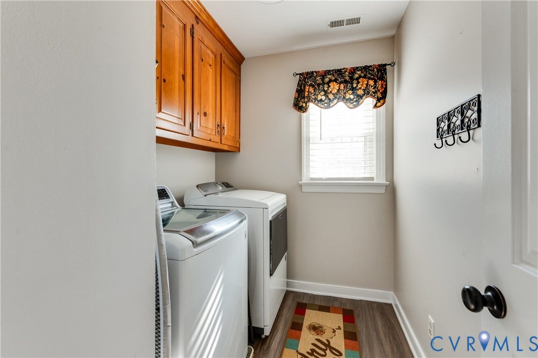 11611 Riverpark Way, Chesterfield, VA 23838 Dedicated laundry area featuring wood-finish flooring, built-in wooden cabinetry, and a window with blinds