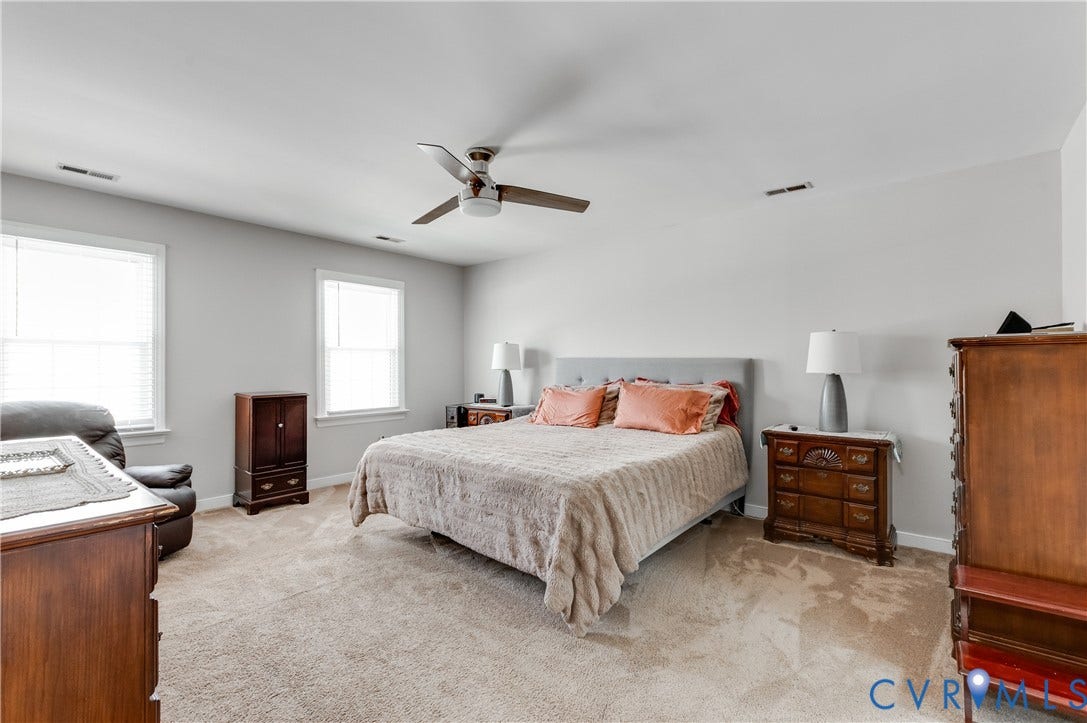 11611 Riverpark Way, Chesterfield, VA 23838 Spacious room featuring neutral carpeting, light-toned walls, and a ceiling fan with integrated lighting