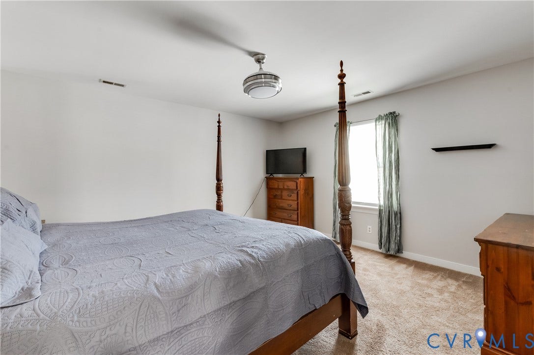 11611 Riverpark Way, Chesterfield, VA 23838 Bedroom featuring neutral wall paint, a single window with curtain rods, light-colored carpet flooring, and a ceiling fan with integrated lighting