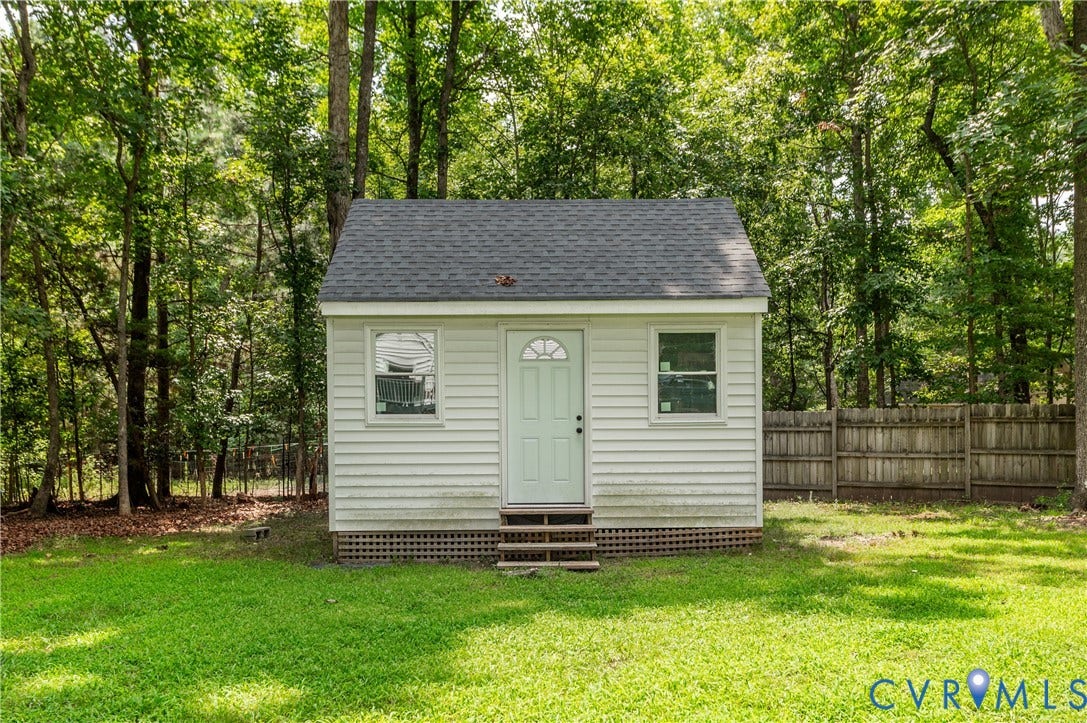 11611 Riverpark Way, Chesterfield, VA 23838 Detached structure featuring white horizontal siding, a dark shingle roof, and a single entry door with an arched window