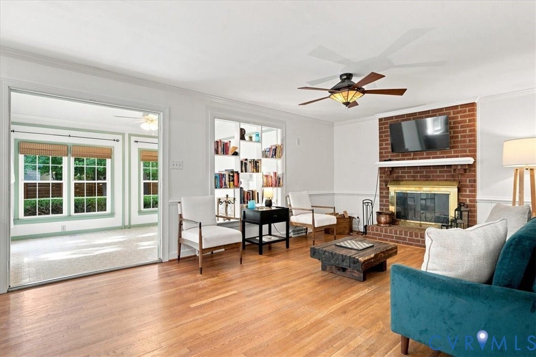 10204 Steuben Drive, Henrico, VA 23060 Living area featuring wood-finish flooring, a brick fireplace with a white mantle, and an integrated ceiling fan