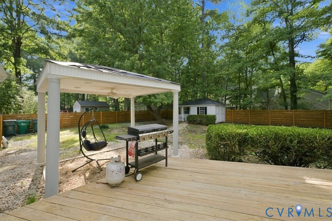 10204 Steuben Drive, Henrico, VA 23060 Spacious wood-finish deck with an integrated covered patio featuring a ceiling fan