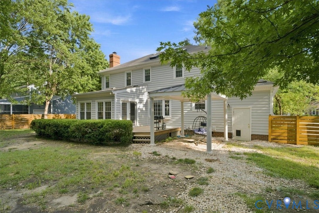 10204 Steuben Drive, Henrico, VA 23060 Rear exterior with light-colored siding, featuring a multi-level deck, an attached covered patio, and a sunroom extension