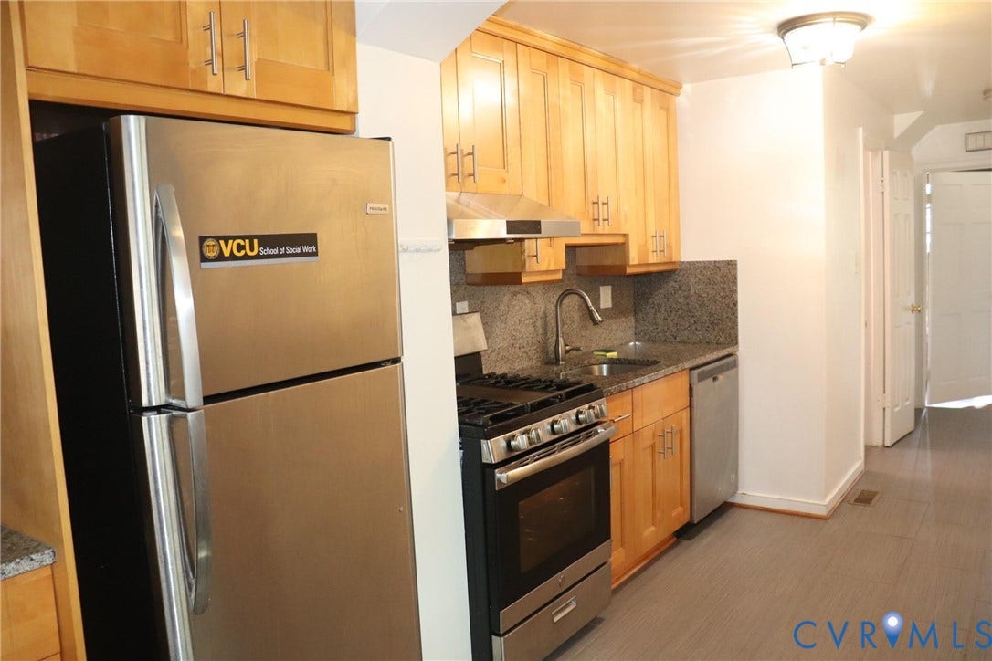 1119 W Grace Street, The Fan District, Richmond, VA 23220 Kitchen featuring light wood cabinetry, stainless steel appliances, granite countertops, and a full-height granite backsplash