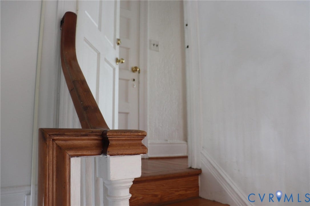 1119 W Grace Street, The Fan District, Richmond, VA 23220 Staircase with wood-finish treads and a painted white baluster featuring a wood-finish newel post and handrail