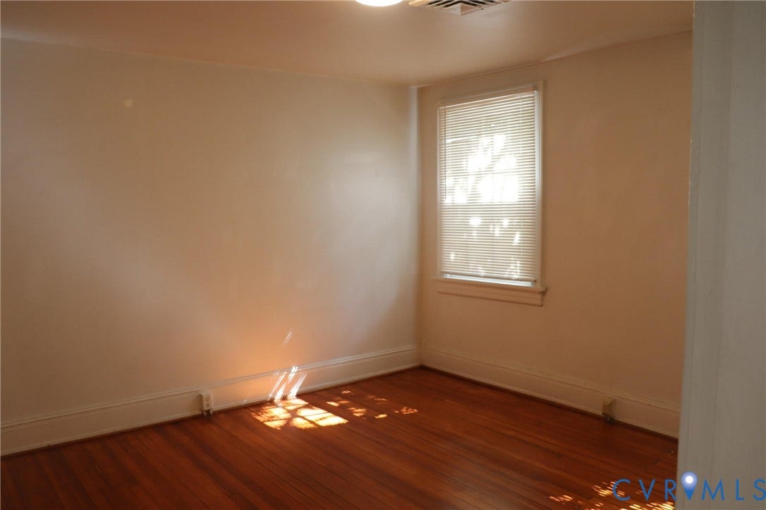1119 W Grace Street, The Fan District, Richmond, VA 23220 Hardwood flooring throughout featuring white baseboards, a window with blinds, and white wall finishes
