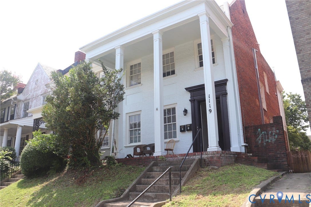 1119 W Grace Street, The Fan District, Richmond, VA 23220 White brick residence featuring a portico with four columns and a dark-trimmed entry