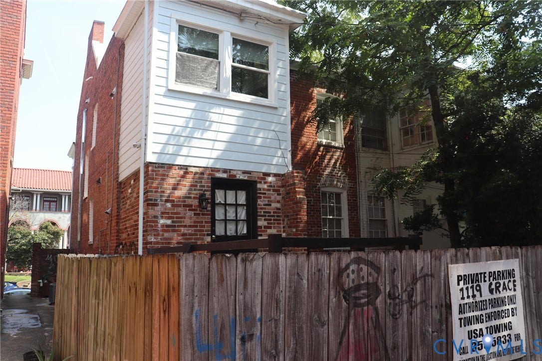 1119 W Grace Street, The Fan District, Richmond, VA 23220 Brick and white siding exterior featuring multiple windows and a black door