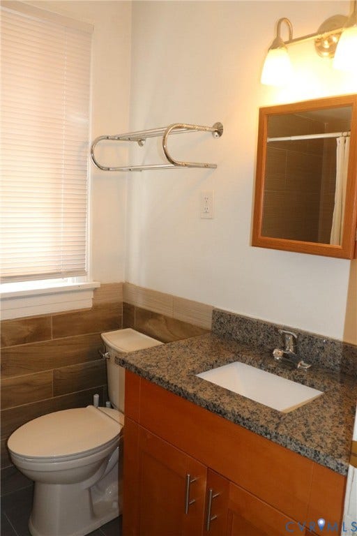 1119 W Grace Street, The Fan District, Richmond, VA 23220 Bathroom featuring a wood-tone vanity with a speckled countertop, an integrated sink, and an overhead light fixture