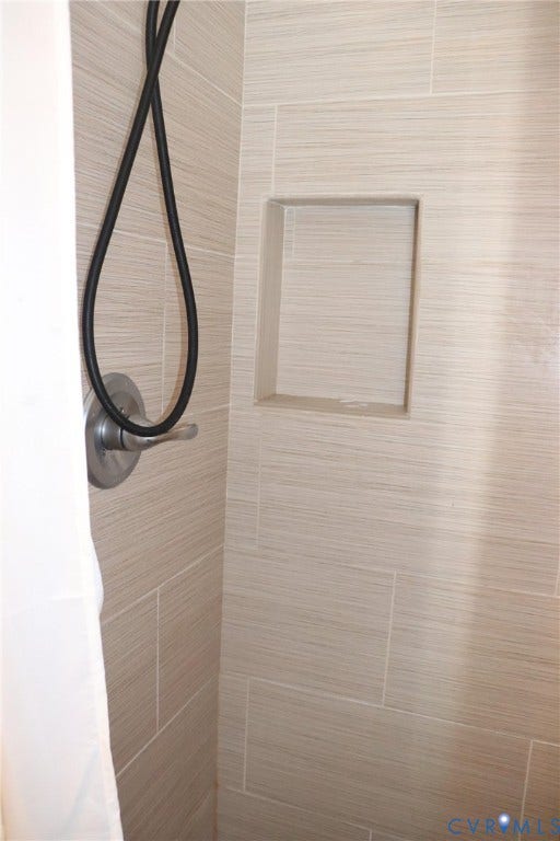 1119 W Grace Street, The Fan District, Richmond, VA 23220 Shower stall featuring a tiled niche, brushed nickel shower control, and a flexible shower hose