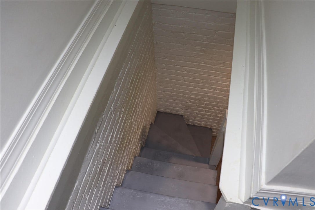 1119 W Grace Street, The Fan District, Richmond, VA 23220 Staircase with painted brick wall and white trim detail