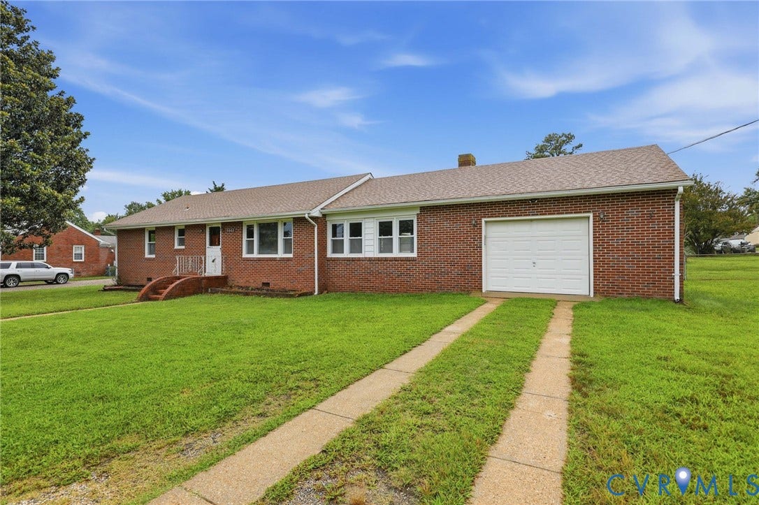 5002 Glendale Avenue, Dinwiddie, VA 23803 Brick exterior, attached garage, concrete driveway, front porch, and shingled roof