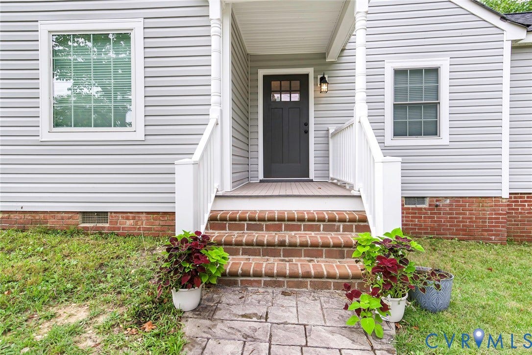 501 Pelham Drive, Richmond, VA 23222 Front entry featuring a dark-paneled door with upper glass inserts, white porch columns, white railings, and brick stairs