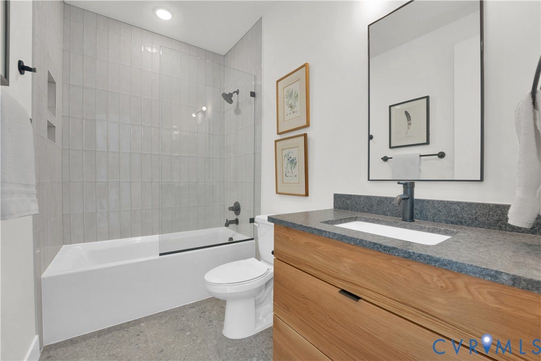 4506 1/2 Grove Avenue, Munford On Grove, Richmond, VA 23221 Bathroom featuring a wood-finish vanity with a dark countertop, an undermount sink, and matte black fixtures