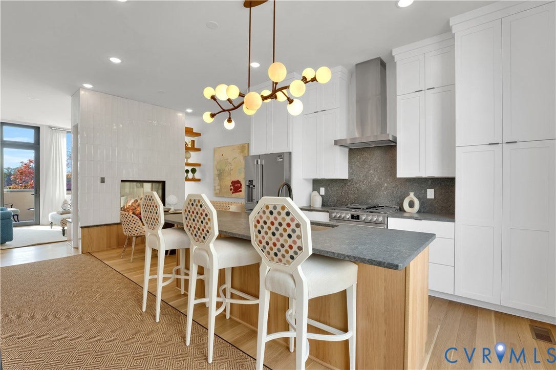 4506 1/2 Grove Avenue, Munford On Grove, Richmond, VA 23221 Contemporary kitchen featuring a large island with seating, a built-in gas range with stainless steel hood, white cabinetry, and light wood-finish flooring
