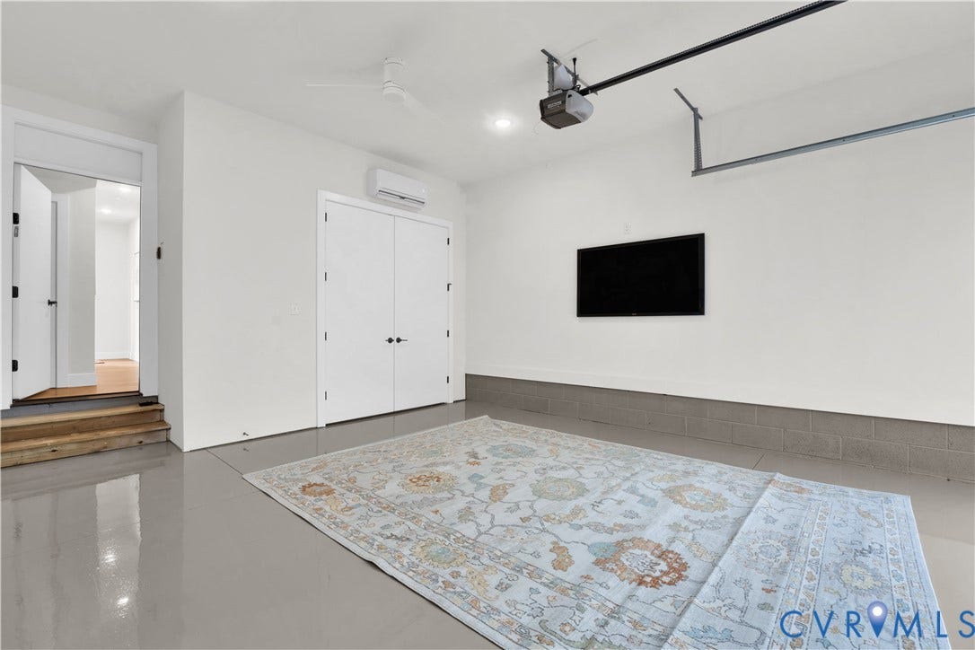 4506 1/2 Grove Avenue, Munford On Grove, Richmond, VA 23221 Garage space featuring a smooth finished floor, ceiling fan, and wall-mounted climate control unit