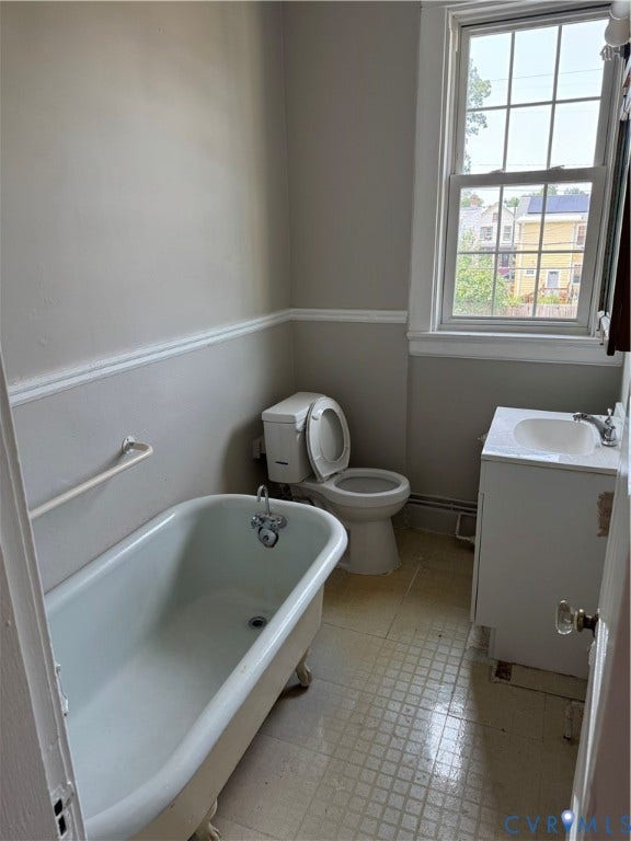 3118 Barton Avenue, Brookland Park, Richmond, VA 23222 Classic bathroom featuring a freestanding soclaium tub with claw feet, pedestal sink, and low-profile toilet
