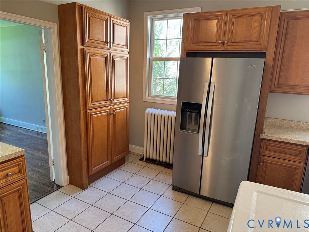 3118 Barton Avenue, Brookland Park, Richmond, VA 23222 Stainless steel side-by-side refrigerator, tile flooring, window with natural light, wood-finish cabinetry, and built-in pantry
