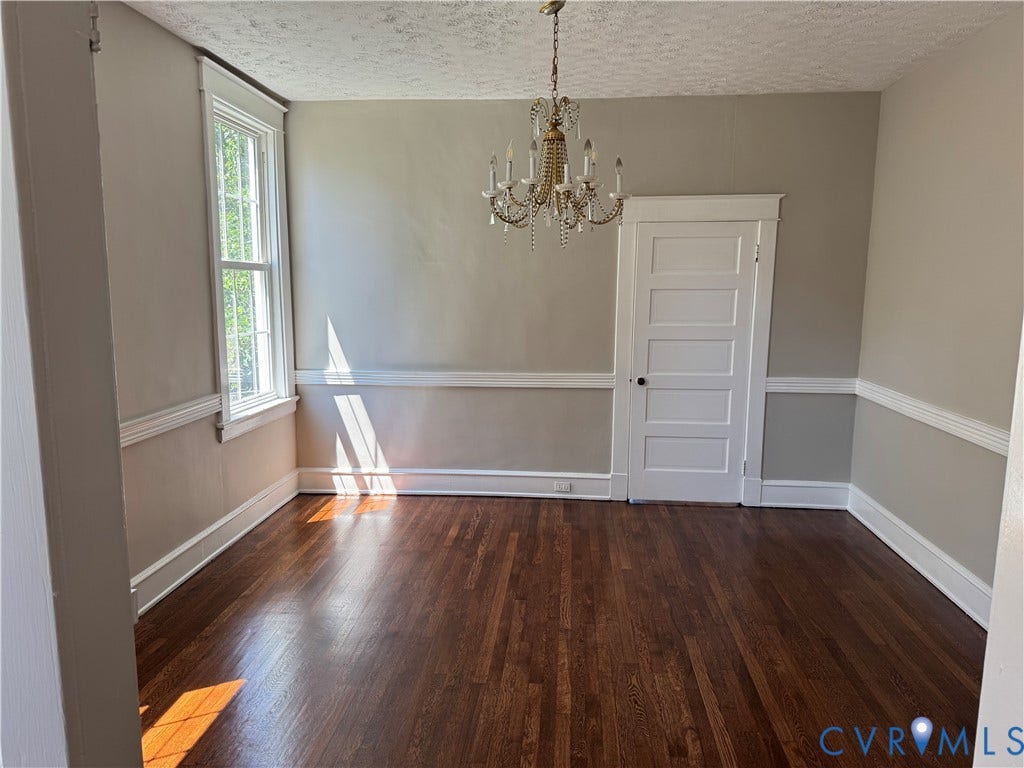 3118 Barton Avenue, Brookland Park, Richmond, VA 23222 Formal Dining Room with 10' ceilings, Hardwood flooring, decorative chandelier, paneled door, window with white trim, and wall molding