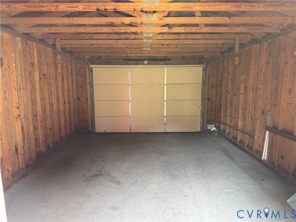 3118 Barton Avenue, Brookland Park, Richmond, VA 23222 Garage with concrete flooring, wood-paneled walls, and exposed ceiling beams