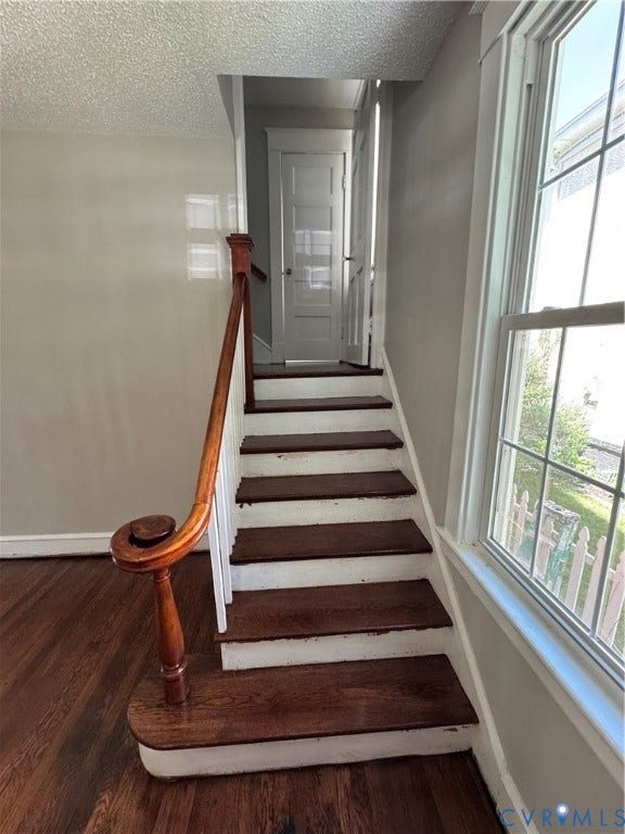 3118 Barton Avenue, Brookland Park, Richmond, VA 23222 Wood-finish flooring, staircase with wood treads, wood newel post with scroll detail, and multi-pane window