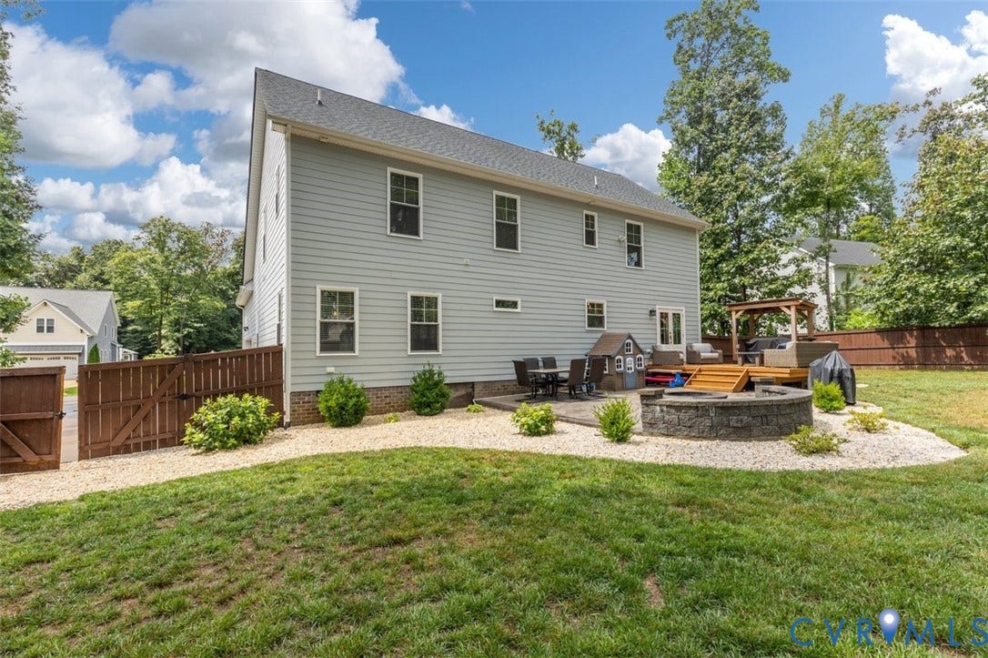 9081 Deerlake Drive, Charming, New Kent, VA 23124 Expansive backyard featuring a stone fire pit, wood deck with a pergola, and a paver patio, shed, and fenced rear yard