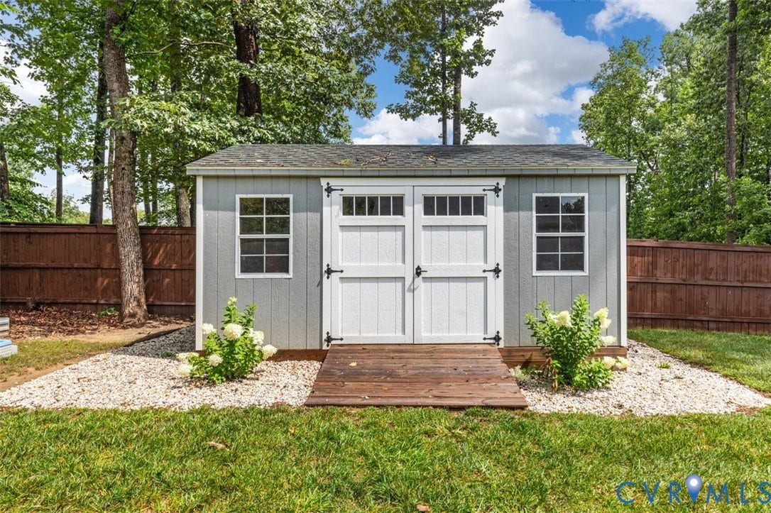 9081 Deerlake Drive, Charming, New Kent, VA 23124 Exterior storage shed with a shingled roof and white double doors featuring transom windows