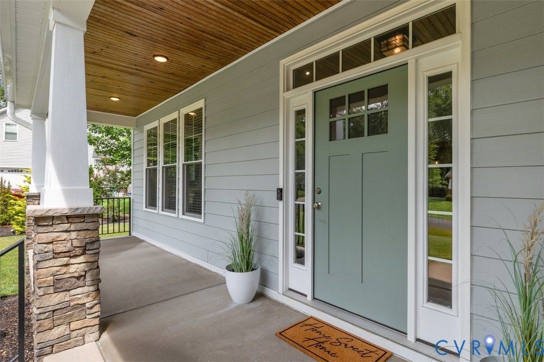 9081 Deerlake Drive, Charming, New Kent, VA 23124 Inviting front porch featuring a wood-finish ceiling with recessed lighting, stacked stone column bases, and a light green entry door with sidelights and transom windows