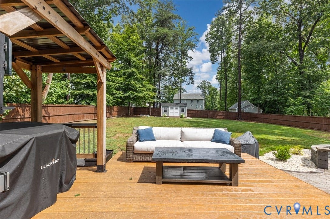 9081 Deerlake Drive, Charming, New Kent, VA 23124 Spacious outdoor deck featuring pergola, expansive lawn, privacy fencing, and a separate storage shed. Pergola offers plug in options for charging phones, computers, etc