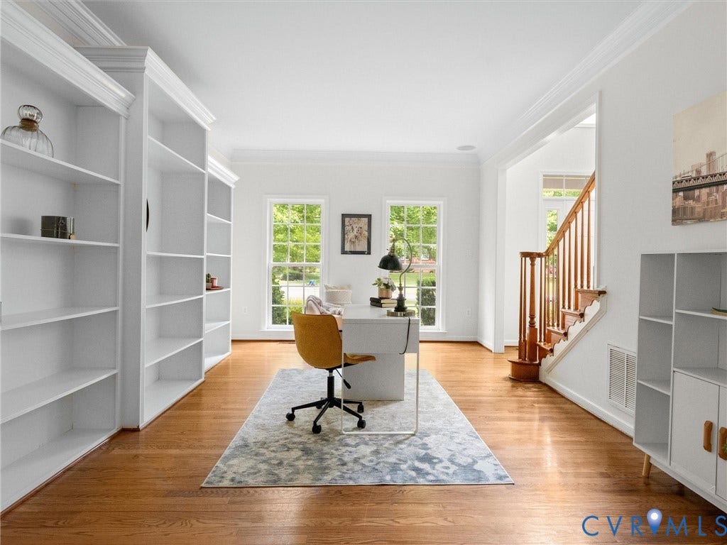 6100 Lilting Branch Way, Moseley, VA 23120 Hardwood flooring throughout, built-in shelving, white trim, and a wood staircase with balusters