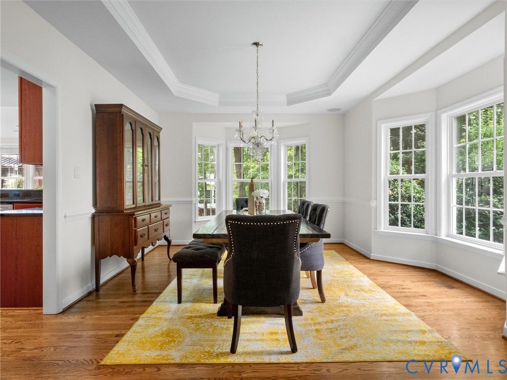 6100 Lilting Branch Way, Moseley, VA 23120 Tray ceiling with crown molding, wood-finish flooring, bay window, chandelier, and chair rail molding
