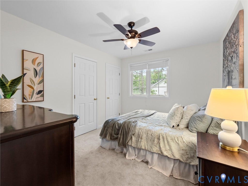6100 Lilting Branch Way, Moseley, VA 23120 Recessed window with white blinds, ceiling fan with integrated lighting, two paneled doors, and neutral wall paint